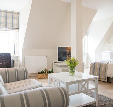 rp-referenzen-deutschland-gluecksburg-strandhotel-zimmer-betten-tisch-fernseher-allgemeinbeleuchtung